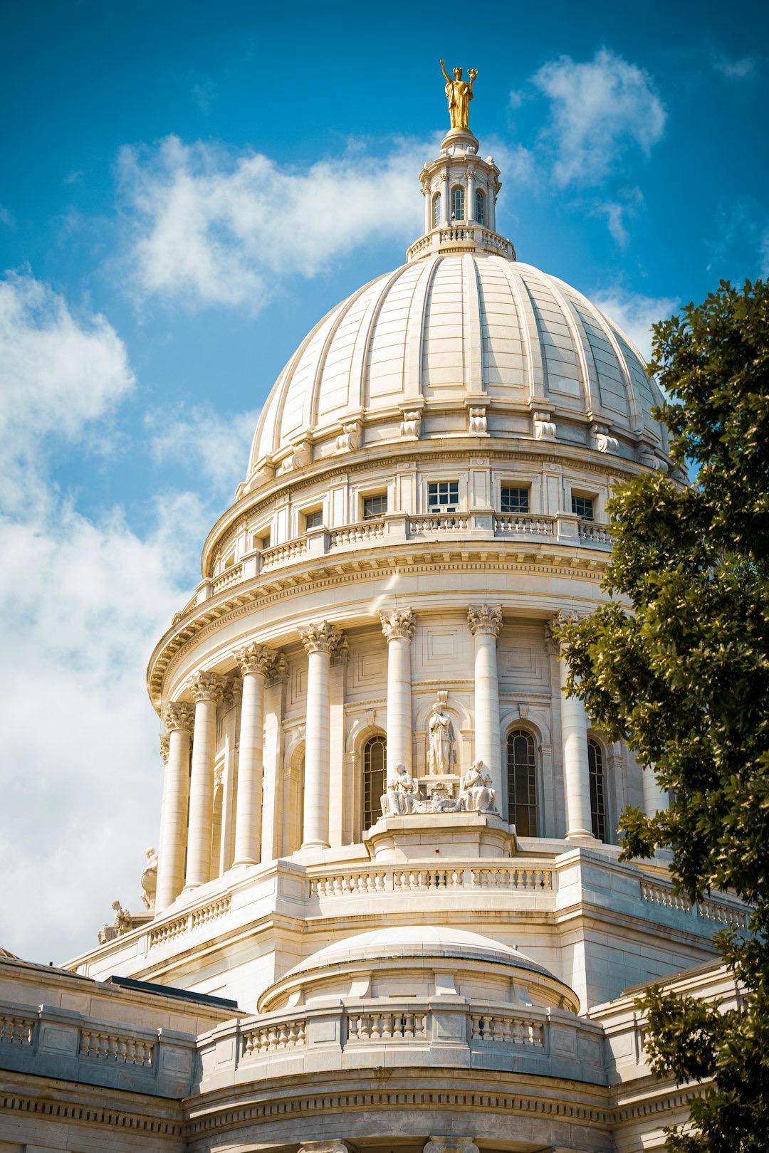 A grand white domed capitol building under a blue sky.
